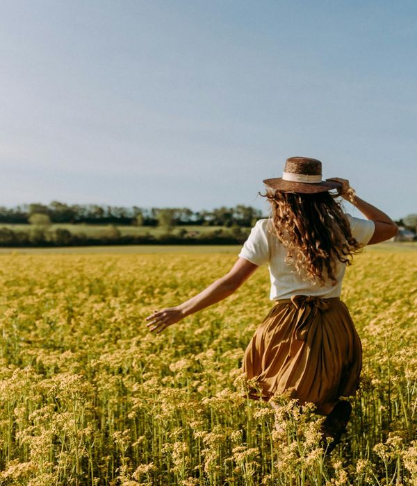Woman feeling energized and full of life in a bright space.
